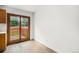 Bright dining room featuring wood-look flooring and doors leading to a backyard deck at 4678 S Lewiston Way, Aurora, CO 80015