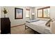 Bright bedroom with a bed, dresser, and mountain views at 464 Ponderosa Dr, Evergreen, CO 80439