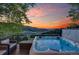 Relax in this hot tub on a deck overlooking stunning mountain views at sunset at 464 Ponderosa Dr, Evergreen, CO 80439