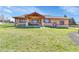 Spacious backyard featuring a well-manicured lawn and covered patio with seating at 5365 Eldridge St, Arvada, CO 80002