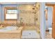 Bathroom featuring a glass shower, soaking tub, and tiled walls at 5365 Eldridge St, Arvada, CO 80002