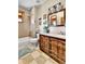 Rustic-style bathroom featuring wood vanity with a vessel sink and shower-tub combination at 5365 Eldridge St, Arvada, CO 80002