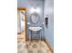 Elegant half bathroom featuring hexagon tile floors and pedestal sink with designer mirror at 5365 Eldridge St, Arvada, CO 80002