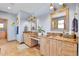 Elegant bathroom featuring double sinks, decorative mirrors, and soft blue walls at 5365 Eldridge St, Arvada, CO 80002