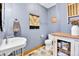 Charming powder room with hexagonal tile flooring, pedestal sink, and decorative accents at 5365 Eldridge St, Arvada, CO 80002