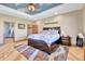 Bright bedroom with hardwood floors, a colorful rug, and a view into the ensuite bathroom at 5365 Eldridge St, Arvada, CO 80002