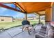 Relaxing covered patio space with wooden picnic tables and comfortable lounge seating at 5365 Eldridge St, Arvada, CO 80002