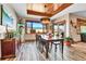 Well-lit dining room featuring a wooden ceiling accent, dining table, and decorative cabinet at 5365 Eldridge St, Arvada, CO 80002