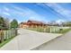 Long concrete driveway leading to a ranch home with a white horse fence at 5365 Eldridge St, Arvada, CO 80002