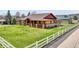 Charming home with a large porch and well-maintained lawn and a white picket fence at 5365 Eldridge St, Arvada, CO 80002