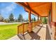 Expansive front porch features wood ceilings and stone columns at 5365 Eldridge St, Arvada, CO 80002