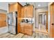 Bright kitchen nook with stainless steel fridge and plenty of cabinet storage and adjacent hallway at 5365 Eldridge St, Arvada, CO 80002