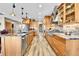 Spacious, open kitchen with marble countertops, stainless steel appliances and wood-look flooring at 5365 Eldridge St, Arvada, CO 80002