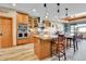 Gourmet kitchen features a large island and wood cabinets at 5365 Eldridge St, Arvada, CO 80002
