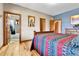 A primary bedroom with ensuite bathroom access and rich natural wood trim accents at 5365 Eldridge St, Arvada, CO 80002