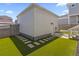 The backyard features artificial turf and a stone path leading to a basement door at 175 Westerly Blvd, Erie, CO 80516