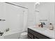 Clean bathroom featuring a combined bathtub and shower, white tile, and modern fixtures at 175 Westerly Blvd, Erie, CO 80516