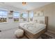 Inviting bedroom with plush bedding, bright windows, and scenic neighborhood views at 175 Westerly Blvd, Erie, CO 80516