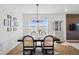 Elegant dining room with modern chandelier and open layout to living room at 175 Westerly Blvd, Erie, CO 80516