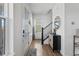 Bright foyer with wood floors, a stylish console table, and staircase at 175 Westerly Blvd, Erie, CO 80516