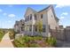 Stylish two-story home with white siding, a covered porch, and attractive landscaping at 175 Westerly Blvd, Erie, CO 80516