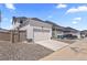 A detached two-car garage with a white door and driveway in the backyard at 175 Westerly Blvd, Erie, CO 80516