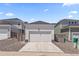 A detached two-car garage with a white door and driveway at 175 Westerly Blvd, Erie, CO 80516