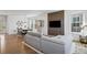 Stylish living room with wood floors, gray couch, modern lighting, and decorative wall panel at 175 Westerly Blvd, Erie, CO 80516
