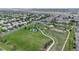 Expansive aerial shot displaying a residential area with green spaces, roads and surrounding neighborhoods at 19730 E 58Th Pl, Aurora, CO 80019