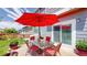 Back patio featuring an outdoor seating area with a red umbrella and a sliding glass door at 19730 E 58Th Pl, Aurora, CO 80019