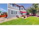Exterior view showcasing a well-maintained backyard with a patio, seating, and lawn at 19730 E 58Th Pl, Aurora, CO 80019