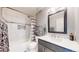 Modern bathroom with a tiled shower-tub, sleek vanity, and contemporary fixtures at 19730 E 58Th Pl, Aurora, CO 80019