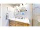 Modern bathroom with double sinks, sleek vanity, and beautifully tiled shower at 19730 E 58Th Pl, Aurora, CO 80019