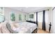 Bright bedroom with a cozy bed, three windows, and a neutral decor at 19730 E 58Th Pl, Aurora, CO 80019