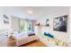 Bright bedroom with a comfortable bed, three windows, and playful decor at 19730 E 58Th Pl, Aurora, CO 80019