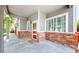 Covered front porch with brick accents, view of front door, and large picture window at 19730 E 58Th Pl, Aurora, CO 80019