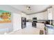 Modern kitchen with stainless steel appliances, white cabinets, and dark countertops at 19730 E 58Th Pl, Aurora, CO 80019