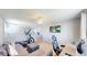 Inviting living room with plush sofa, elliptical machine, and modern decor at 19730 E 58Th Pl, Aurora, CO 80019