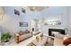 Open-concept living room with fireplace, neutral decor, and view of a bathroom down the hall at 19730 E 58Th Pl, Aurora, CO 80019