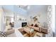 Bright living room with vaulted ceilings, a fireplace, and a large decorative painting at 19730 E 58Th Pl, Aurora, CO 80019