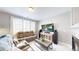 Cozy living room with a TV, comfortable seating, and large windows for natural light at 19730 E 58Th Pl, Aurora, CO 80019