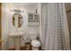 Cozy bathroom with a pedestal sink, toilet, shower and medicine cabinet at 13190 Coyote Song Trl, Conifer, CO 80433