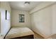 Small bedroom featuring neutral walls and a comfortable bed with an outside view at 13190 Coyote Song Trl, Conifer, CO 80433