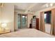 Bedroom with dresser, window view, and sliding glass door for access to the outside at 13190 Coyote Song Trl, Conifer, CO 80433
