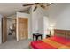 Cozy bedroom featuring carpet floors, a ceiling fan and multiple entryways to different rooms of the home at 13190 Coyote Song Trl, Conifer, CO 80433
