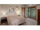 Cozy bedroom features a sliding glass door with outside views at 13190 Coyote Song Trl, Conifer, CO 80433