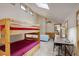 Bedroom with carpet, vaulted ceilings, bunk beds, and desk at 13190 Coyote Song Trl, Conifer, CO 80433