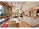 Inviting dining area with wood accents and view of the living room stone fireplace at 13190 Coyote Song Trl, Conifer, CO 80433
