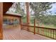 A wide deck offers an outdoor retreat, surrounded by mature trees at 13190 Coyote Song Trl, Conifer, CO 80433