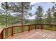 Outdoor retreat, a wide deck is surrounded by mature trees at 13190 Coyote Song Trl, Conifer, CO 80433